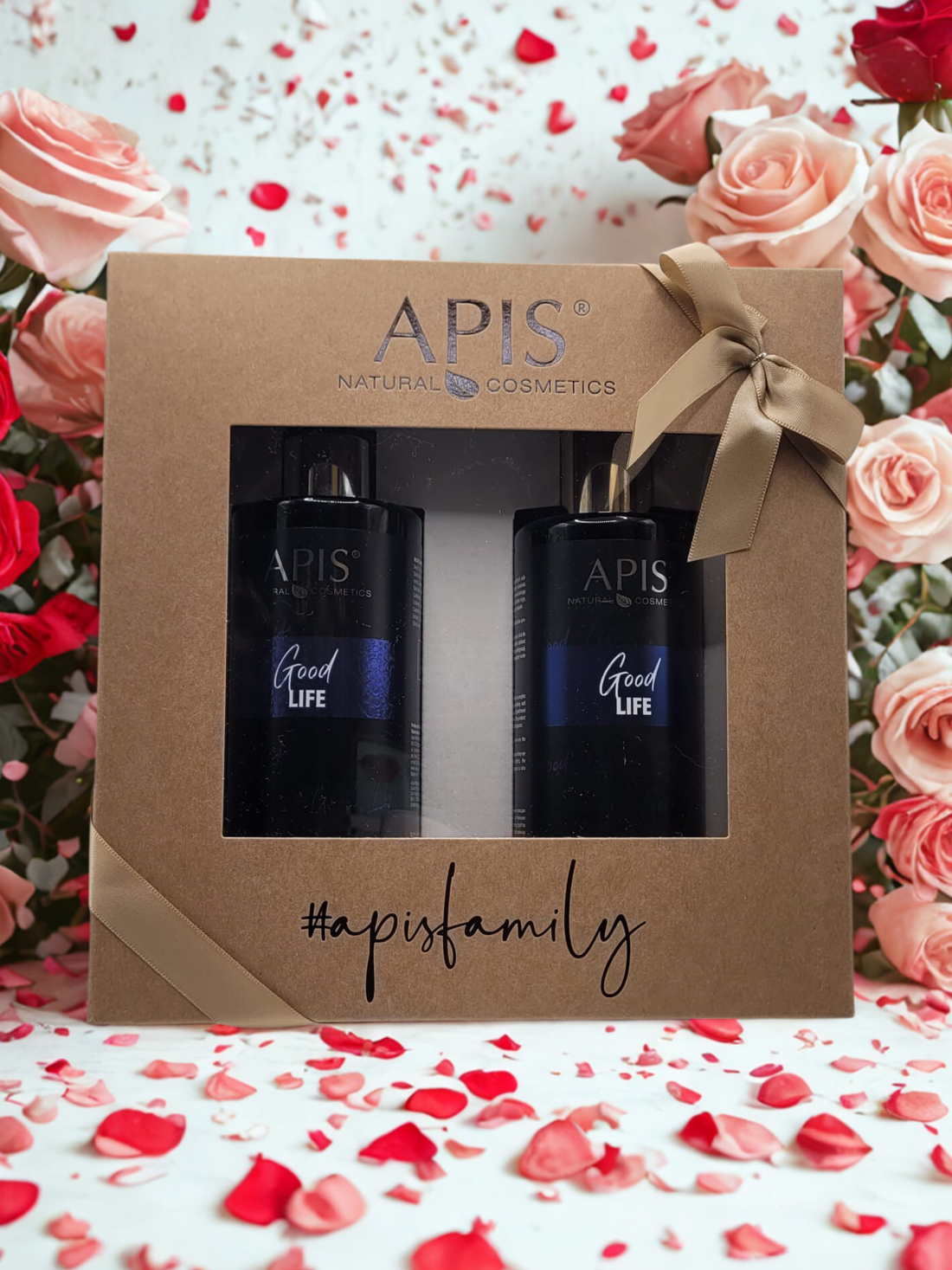 APIS natural cosmetics gift set with bottles in a decorative box on a floral background