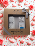 APIS natural cosmetics set in a gift box with decorative flowers and candy on a white background