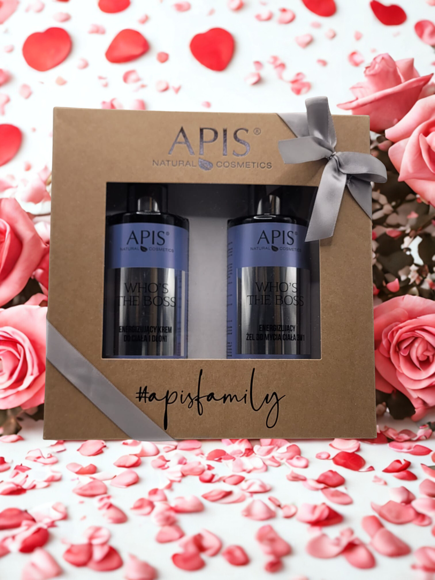 APIS natural cosmetics gift set with bottles and a box on a decorative background with roses and hearts.