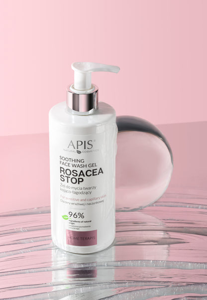APIS Soothing Face Wash Gel Rosacea Stop in a white pump bottle with a silver collar, set against a pink background with a pink reflective surface.